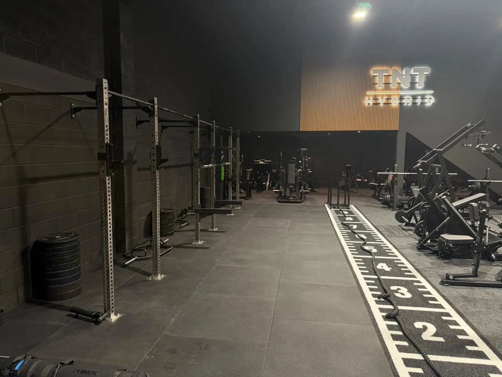 Open functional training space with sled, ropes and kettlebells