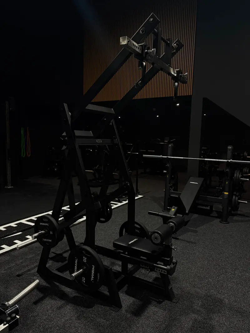 Plate-loaded incline press and Primal strength machines on the open gym floor