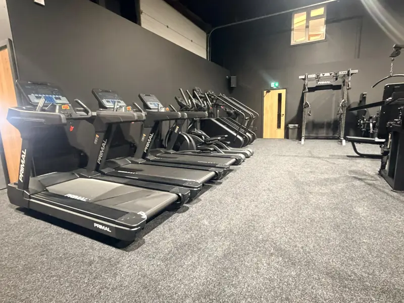 Row of premium Primal treadmills and cardio machines in the cardio zone at TNT Hybrid Settle